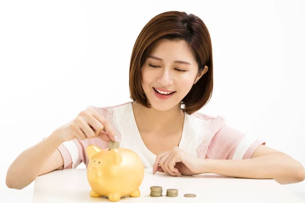 Smiling young Woman Putting Coin In Piggy Bank — Stock Photo, Image