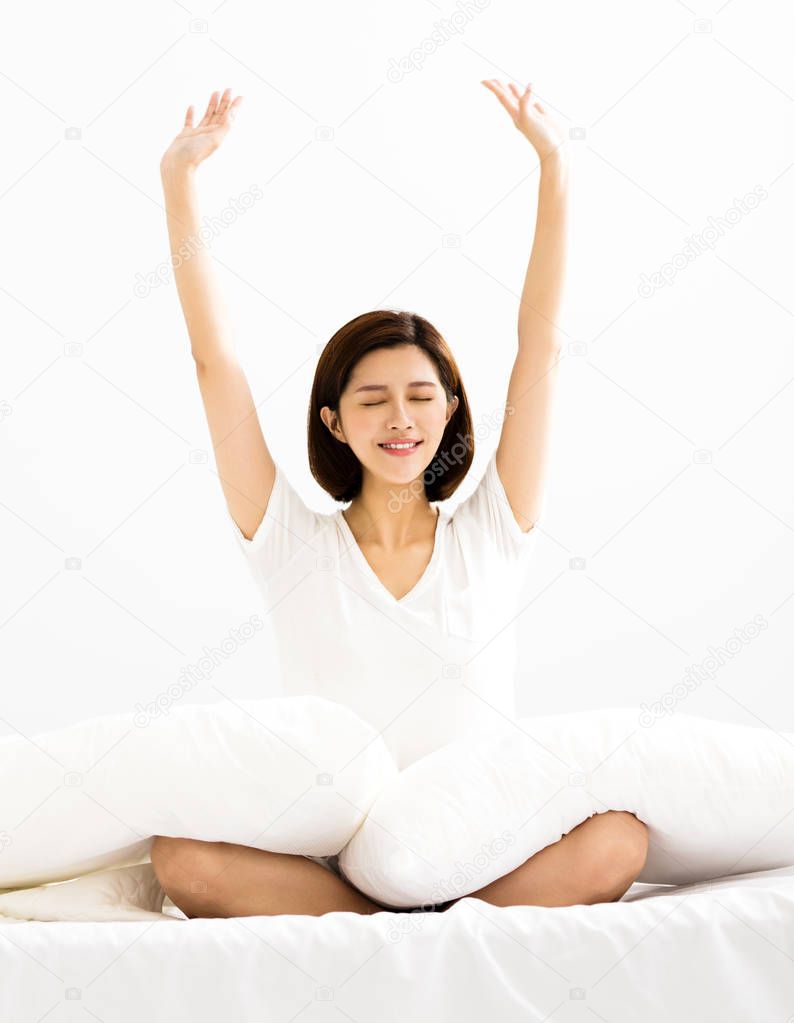 young Woman stretching in bed after wake up