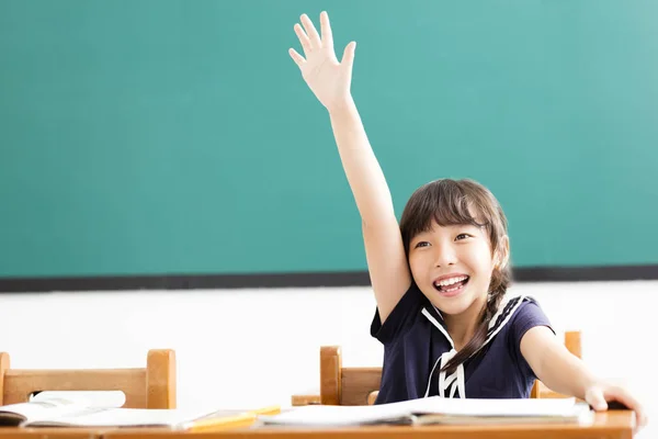 快乐的小女孩举起手在教室里 — 图库照片