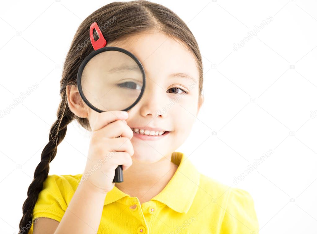 happy little girl with magnifying glass