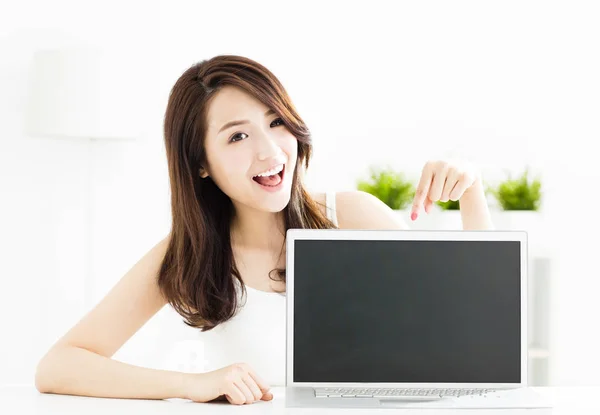 Smiling young woman showing laptop screen Stock Image