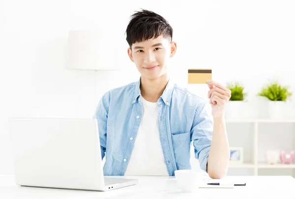 young man buying online with  credit card and laptop