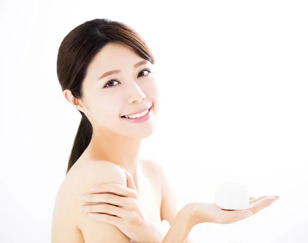 Beautiful young woman showing beauty product on hand — Stock Photo, Image