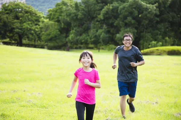 Heureuse petite fille courir dans campagne avec père — Photo