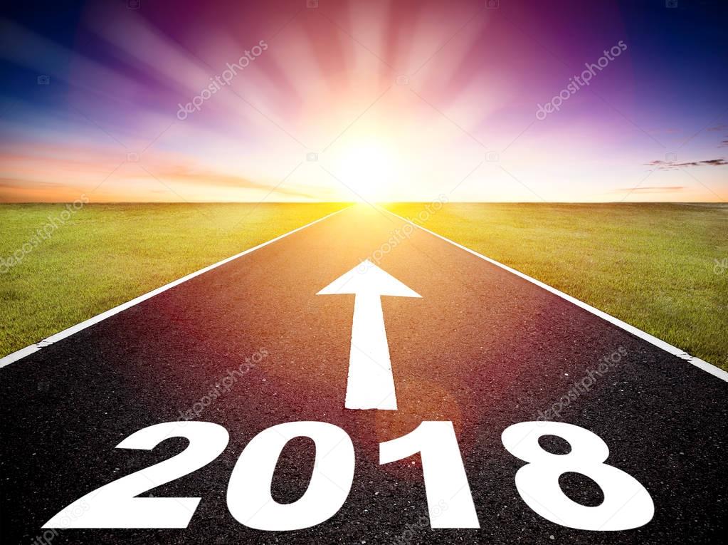 Driving on an empty road and happy new year 2018 concept