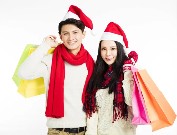 Happy young couple with christmas shopping — Stock Photo, Image