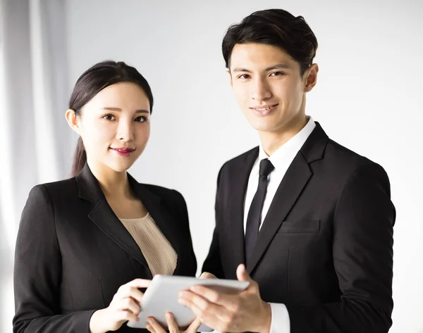 Beautiful young businesswoman with colleague — Stock Photo, Image