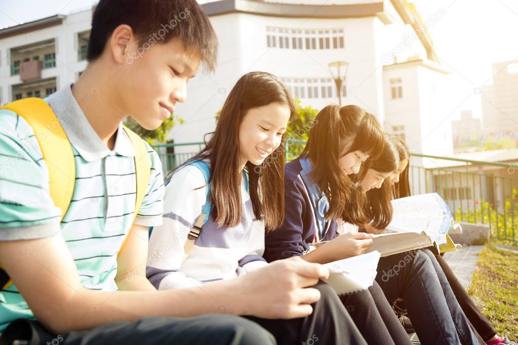 Teenage Students sitting and studying at campus