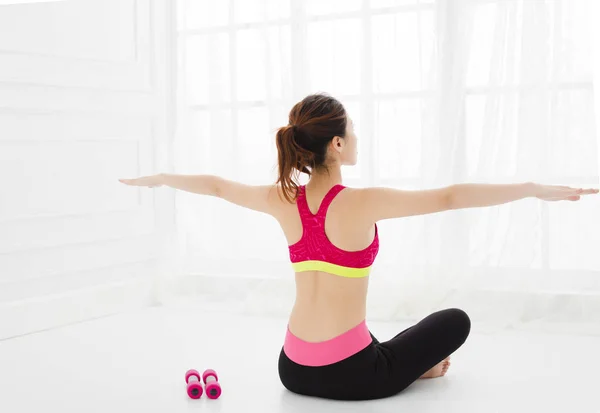 attractive young woman exercising in the room