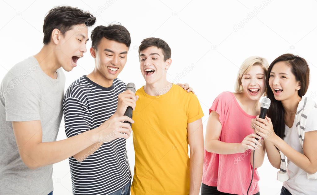 Group of happy friends singing song together