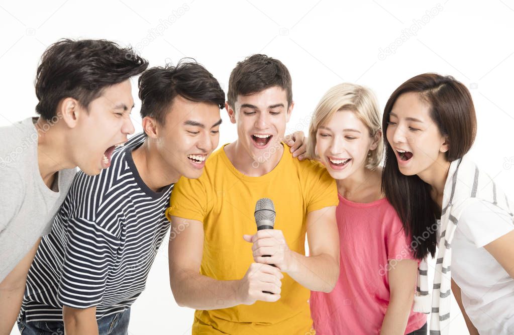 Group of happy friends singing song together
