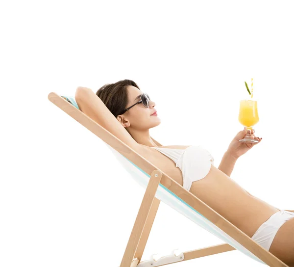Jonge vrouw in lounge stoel met cocktail — Stockfoto