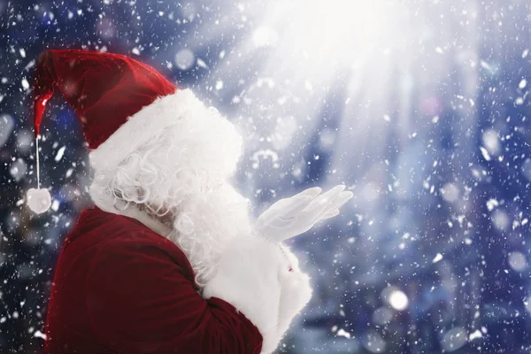 Santa Claus with magic Christmas lights — Stock Photo, Image