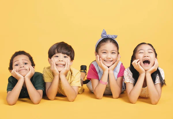 Niños felices acostados juntos en el suelo —  Fotos de Stock