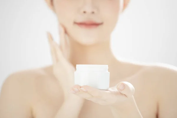 Young woman holding moisturizer cream jar — Stock Photo, Image