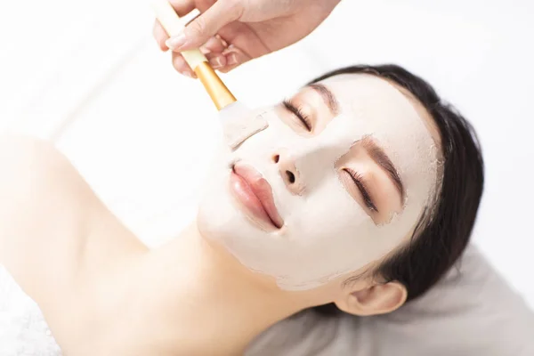 Young Woman with mask on face in spa beauty salon — Stock Photo, Image