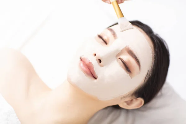 Young Woman with mask on face in spa beauty salon — Stock Photo, Image