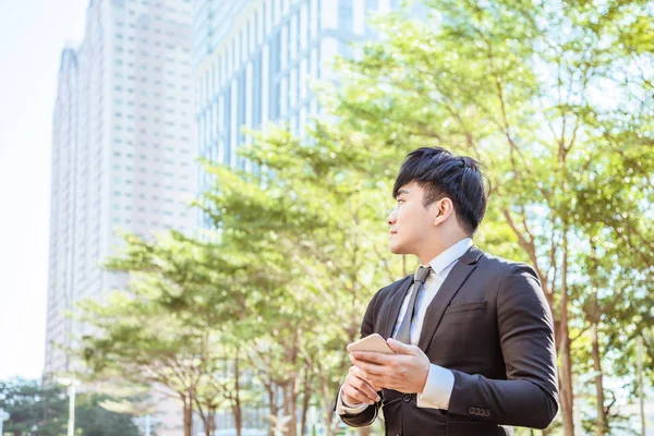 Asiático jovem empresário usando telefone celular — Fotografia de Stock