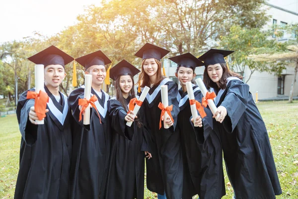 Boldog Diákok Diplomás Ruhák Birtokában Diplomák Egyetemi Campus — Stock Fotó