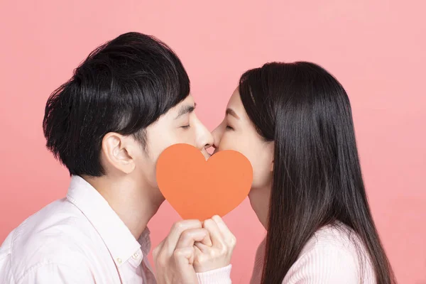 Happy Young Couple Holding Red Paper Hearts Kissing — Stock Photo, Image