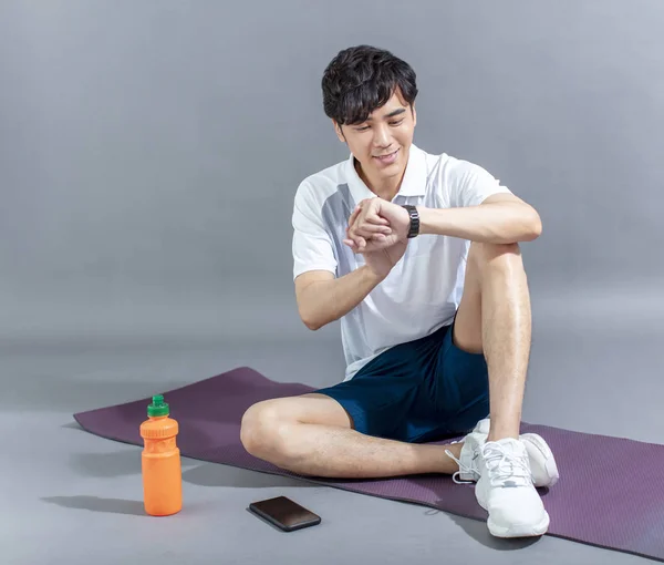 Young Man Runner Doing Stretching Exercise Checking Smart Watch — Stock Photo, Image