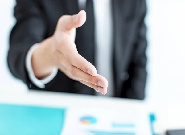 closeup businessman hand reaching out for a handshake