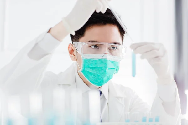 scientist in the laboratory working at lab with test tubes