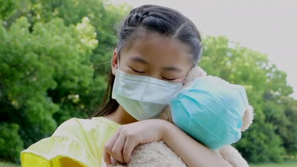 Stress Asian Little Girl Holding Toy Bear Wearing Medical Protective — Stock Video