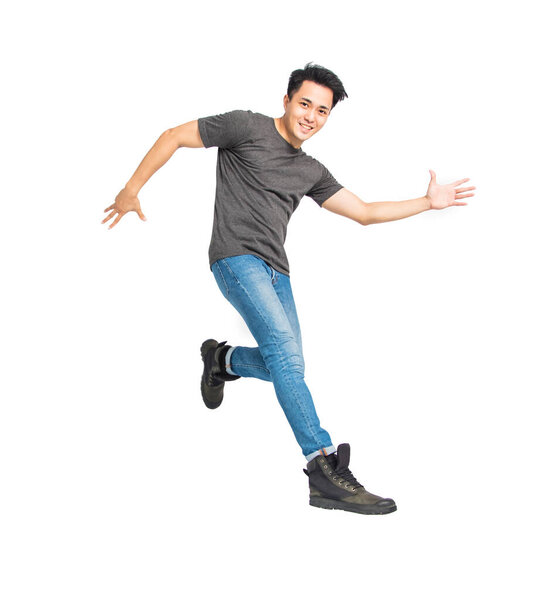 happy young asian man dancing and jumping isolated on white