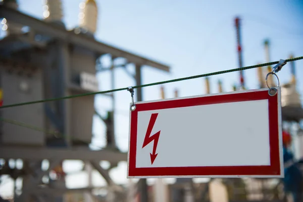 Electrical hazard sign placed on a metal fence