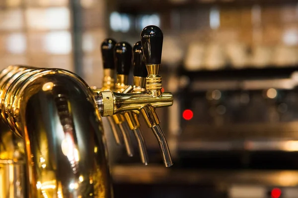 Golden shiny beer taps in beer bar