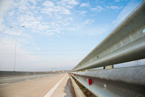 Barrier, guard rail, designed to prevent the exit of the vehicle from the curb or bridge, moving across the dividing strip.