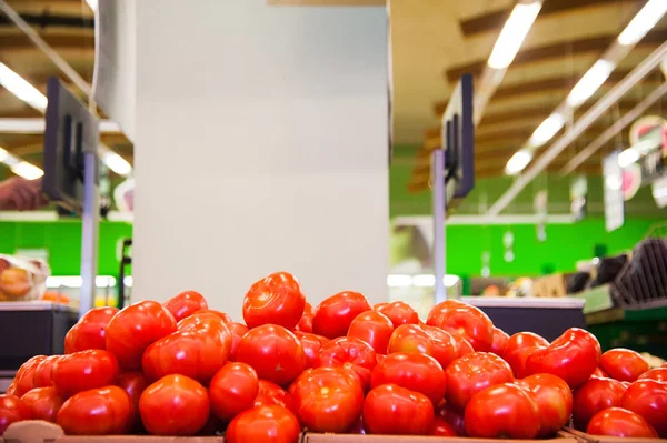 Fresh ripe tomatoes in a box for sale in the grocery shop