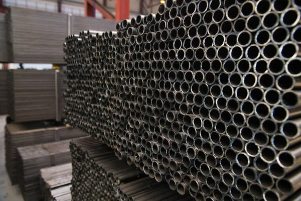 Planta para la producción de tubos metálicos. Pila de tubos de acero —  Fotos de Stock