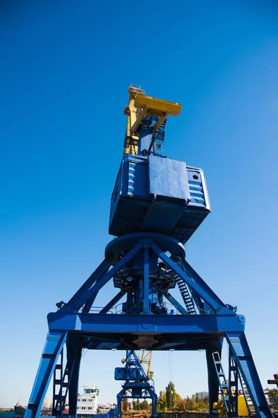 Loading in port. Floating port crane on blue sky background — Stock Photo, Image
