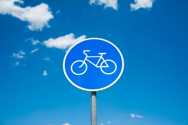 Road sign: Bicycle lane. Road sign against a blue sky.