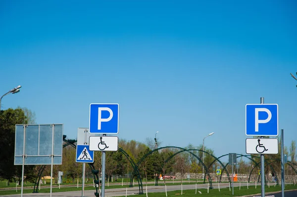 Road sign: for disabled parking. Road sign against a blue sky.