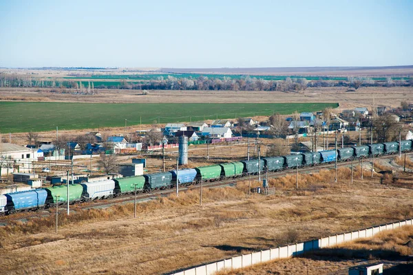 Freight train crossing through railroad station. Railway freight cars and tank cars