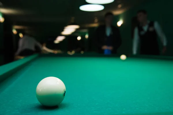 Sports game of billiards on a green cloth. Billiards white billiard balls close up