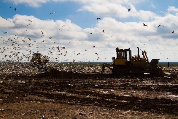 Shot of bulldozers working a landfill site