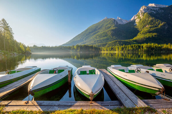 Landscape of Early morning near the lake with boats and mountains. Beautiful sunny holiday. Germany
