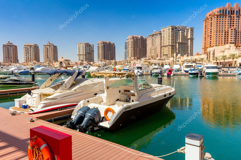 Yachts and boats in harbor marine in summer day, Doha, Qatar. All logos were removed