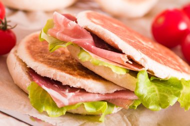 Tigella bread stuffed with ham and lettuce.  clipart