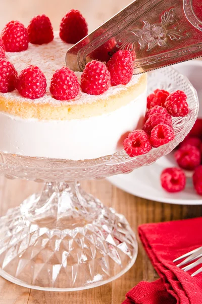 Raspberry cheesecake on glass tray.