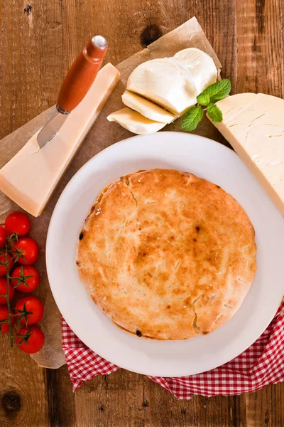 Cheese focaccia bread on wooden table. — Stock Photo, Image