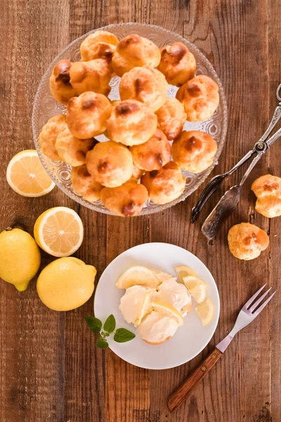 Lemon Profiteroles on white dish. — Stock Photo, Image