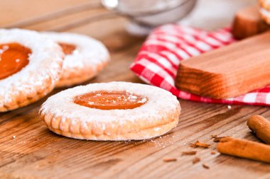 Ahşap masa üzerinde reçelli kahvaltı çerezleri.