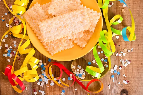 Pâtisserie de carnaval avec confettis sur plat jaune . — Photo
