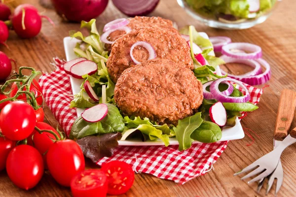 Meatballs with salad on white dish. — Stock Photo, Image