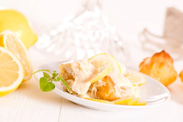 Lemon Profiteroles on white dish. — Stock Photo, Image